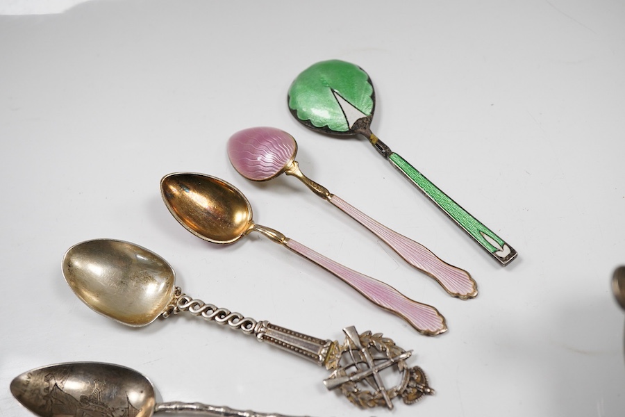 Assorted silverware including a late Victorian mother of pearl handled butter knife, a George V pill box, an Edwardian mustard pot with plated spoon, two enamelled golf related spoons, a rifle shooting related spoon, six
